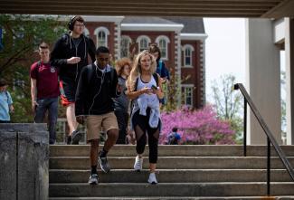 A group of students descend the steps near the Patterson Office Tower