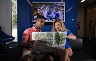 Tour Guides looking at campus map