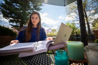 Student outside with homework